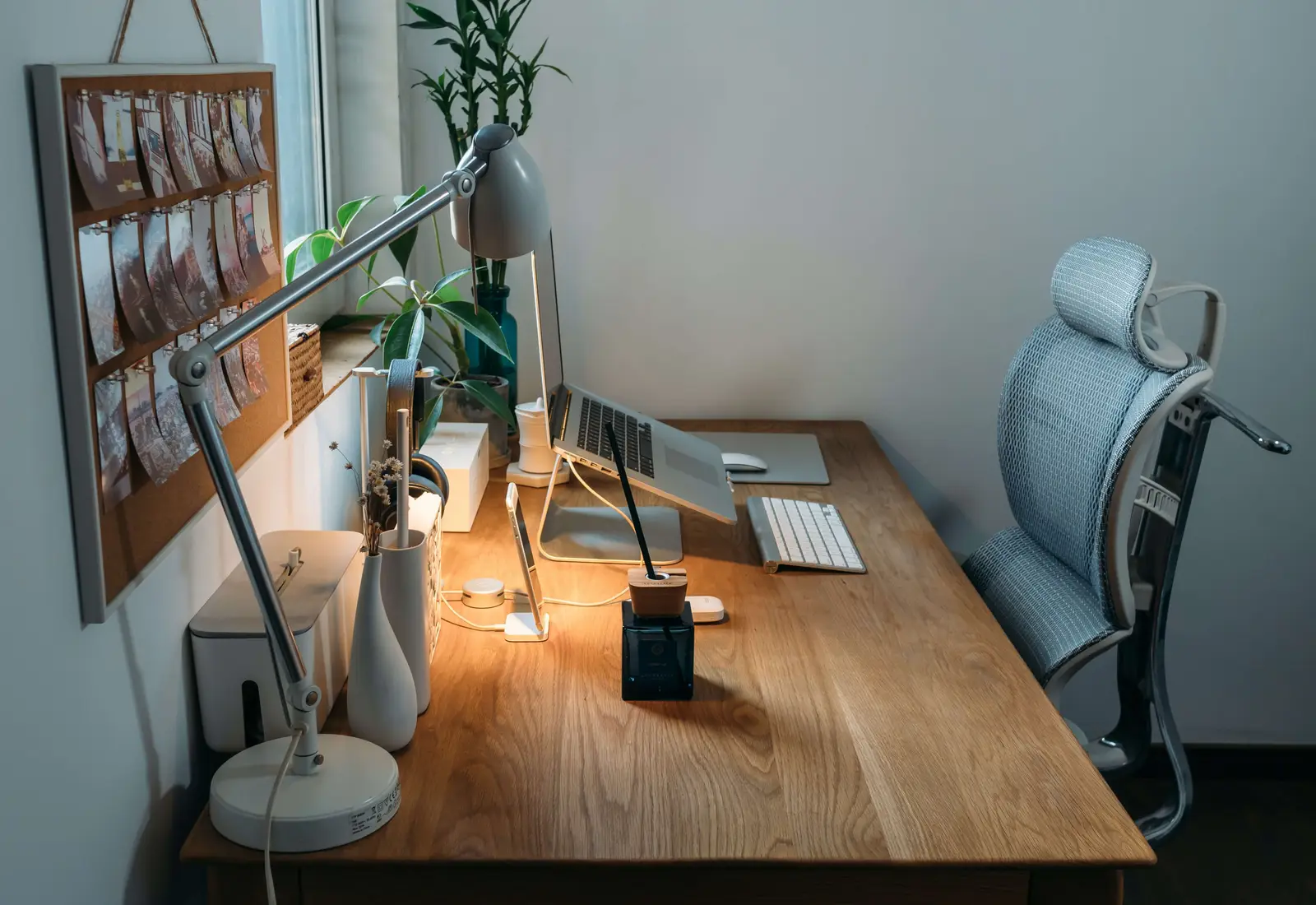 A grey desk lamp on top of an office desk